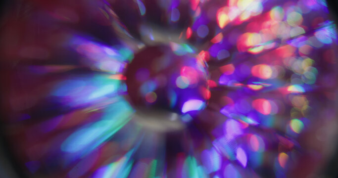 Spectrum light bokeh. Circular glow. Rainbow color shimmering sphere twinkle rays. Neon lens abstract purple red green blur background.