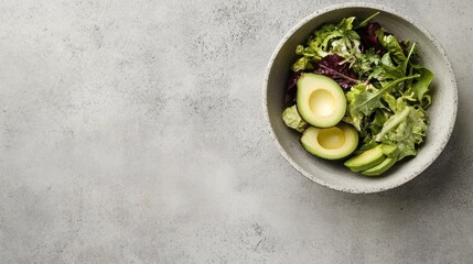 Salad with avocado in bowl on counter background, for healthy eating illustration