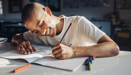 young man writing on a notebook