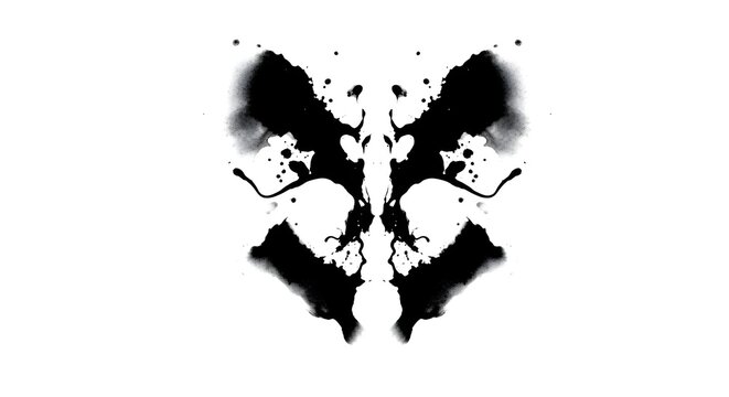 An abstract symmetrical inkblot design resembling a butterfly or a face created with black ink splashes on a white background
