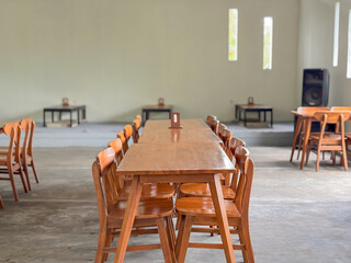 Empty Modern Cafe Interior with Long Wooden Tables and Chairs