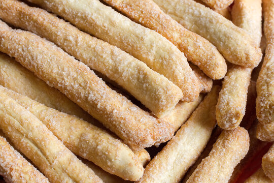 Close-up of sweet biscuits breadsticks. Texture of Long Cookies