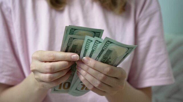 In a quiet room, a sick woman takes a deep breath as she counts bills. Each dollar represents a step toward healing and hope, as medical costs weigh heavily on her mind.