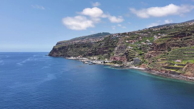 Aerial approach toward dramatic steep coastline of Calheta, Madeira, Portugal