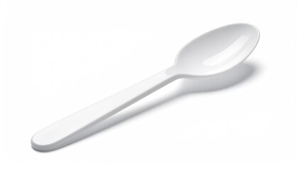 White plastic spoon casting shadow on white backdrop
