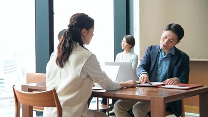 A group of casual business people meeting in a lobby - Powered by Adobe