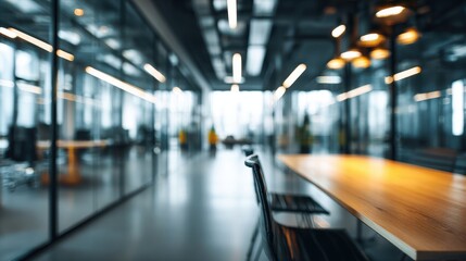 Beautiful photo of blurred background of modern office with glass walls and a table in the foreground.