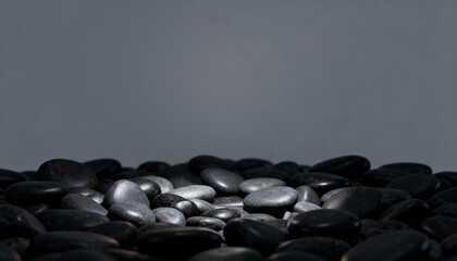 Black and white pebbles on a beach background with texture from the sea and ocean shore