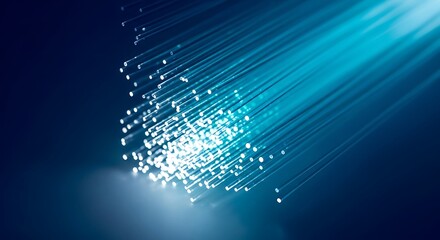 Obraz premium A cluster of bright blue fiber optic strands emitting light rays against a deep blue background.