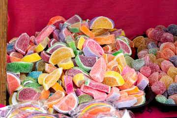 A pile of colorful fruit-flavored gummy bears. The gummy bears are in various colors and shapes....