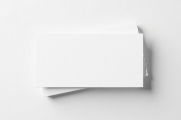 Blank Rectangular Cards Stacked on White Surface, Ideal for Mockup Designs and Presentation of Branding Materials
