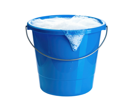 A blue bucket overflows with frothy white bubbles, handle arched, dark background