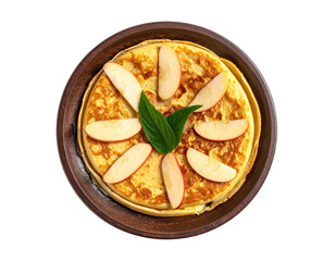 Overhead view of a stack of fluffy pancakes topped with apple slices on a wooden plate
