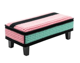 A rectangular footstool with colorful woven exterior, dark legs, against black