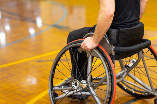 close image of the lower half of a man in a wheelchair on a basketball court