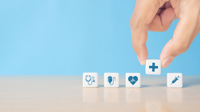 Hand chooses a emoticon icons healthcare medical symbol on dice , Healthcare and medical Insurance concept