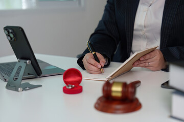 Lawyer Taking Notes During Client Consultation