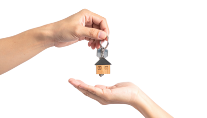Hand Giving House Key with a House Shaped Key Chain Isolated on Transparent Background