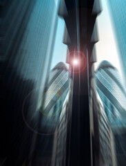 Dynamic urban cityscape with modern architectural towers viewed upwards. Intense blurred effect, a...