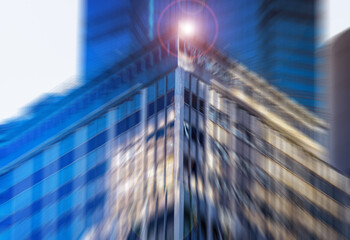 Striking urban architectural view of a modern building corner. Intense radial blur and a bright...