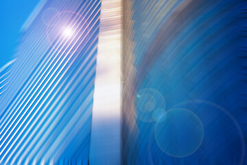 Dynamic urban architectural lines with a vibrant blue hue, blurred with a radial effect, suggesting movement and modern design.