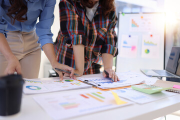Business person hands working with business financial graph data and marketing plan at desk in office, Business people meeting explaining and business concept.