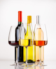 Fototapeta premium Different wine bottles and glasses on white background
