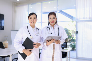 Two medical doctors woman checking the patient papers in  hospital, Medical technology and Healthcare concept. 