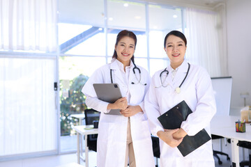 Two medical doctors woman checking the patient papers in  hospital, Medical technology and Healthcare concept. 