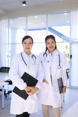 Two medical doctors woman checking the patient papers in  hospital, Medical technology and Healthcare concept. 