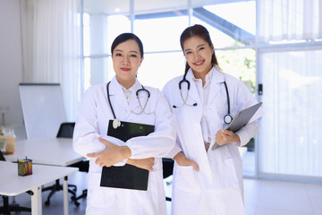 Two medical doctors woman checking the patient papers in  hospital, Medical technology and Healthcare concept. 