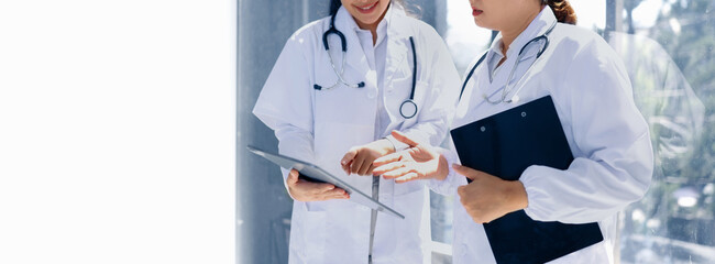 Two medical doctors woman checking the patient papers in  hospital, Medical technology and Healthcare concept. 
