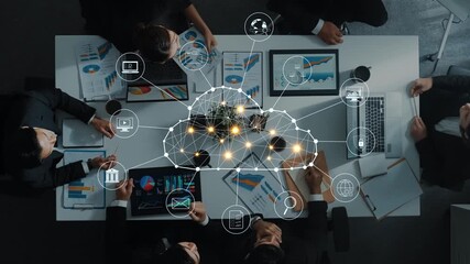Aerial view of a diverse group of professionals gathered around a conference table, utilizing digital tools to discuss modern strategies and data insights for business. Raster - Powered by Adobe