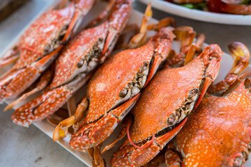 Freshly steamed blue crabs served whole on plate. Traditional Thai seafood delicacy
