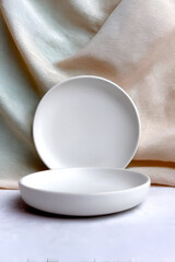 Elegant white plates stacked on a soft background, perfect for showcasing culinary creations and minimalist decor.
