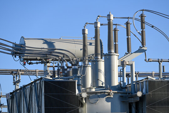 High-voltage electrical infrastructure at a battery plant, showing insulators, bushings, and conductors integral to grid connection and energy storage system operation