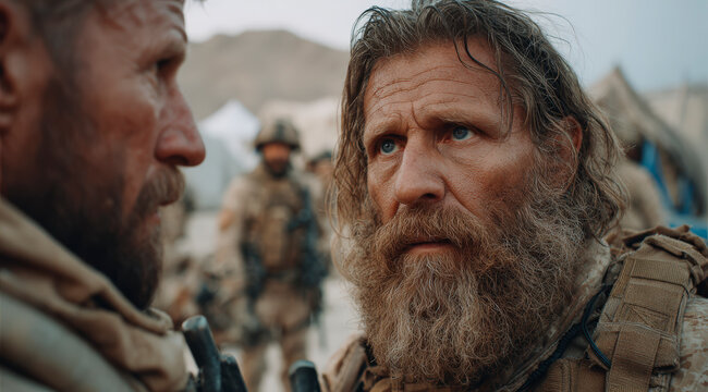 Two bearded soldiers in combat gear engage in a serious discussion in a military encampment with other personnel in the background. - Powered by Adobe