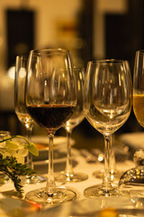 Red and white wine glasses on a beautifully set table, Fine dining and wine, Luxury table setting.