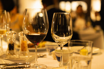 Red and white wine glasses on a beautifully set table, Fine dining and wine, Luxury table setting.