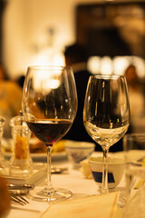 Red and white wine glasses on a beautifully set table, Fine dining and wine, Luxury table setting.
