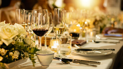 Red and white wine glasses on a beautifully set table, Fine dining and wine, Luxury table setting.