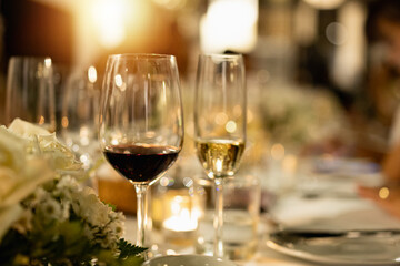Red and white wine glasses on a beautifully set table, Fine dining and wine, Luxury table setting.