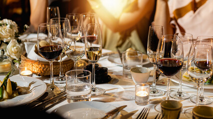 Red and white wine glasses on a beautifully set table, Fine dining and wine, Luxury table setting.