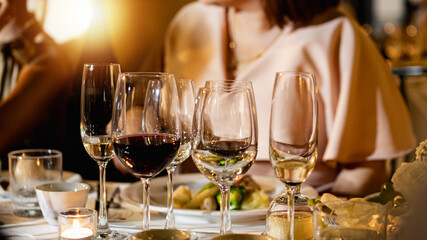 Red and white wine glasses on a beautifully set table, Fine dining and wine, Luxury table setting.