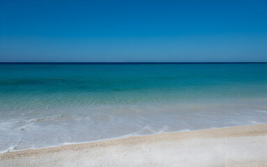 Obraz premium Idyllic beach with turquoise water and white sand under a clear blue sky.