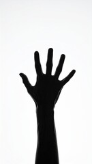 Fototapeta premium Silhouetted hand reaching up against a bright white background
