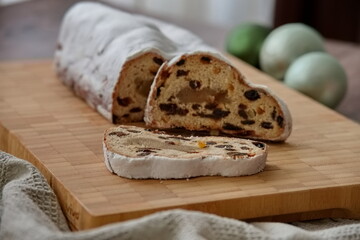 Christmas bread on cutting board with balls in the background