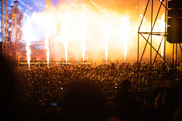 Crowd at concert and blurred stage lights.