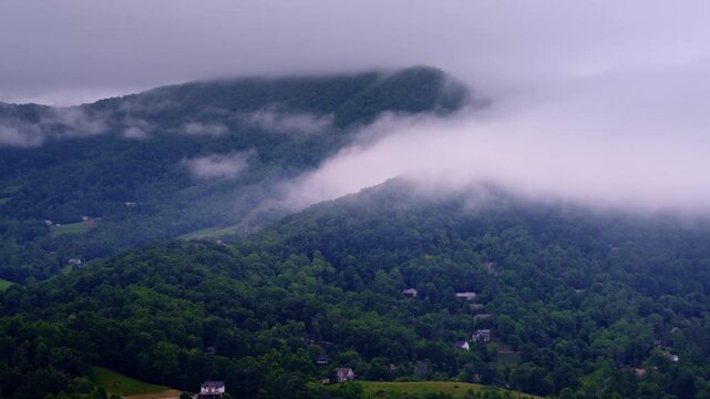 Cinematic flyover revealing a mist-soaked Smoky Mountain valley at dawn.