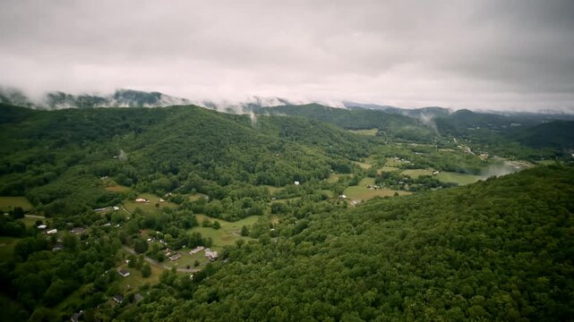 Drone footage flying through a tranquil, fog-soaked Smoky Mountain valley.